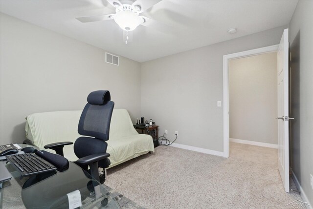 home office featuring a ceiling fan, carpet, visible vents, and baseboards