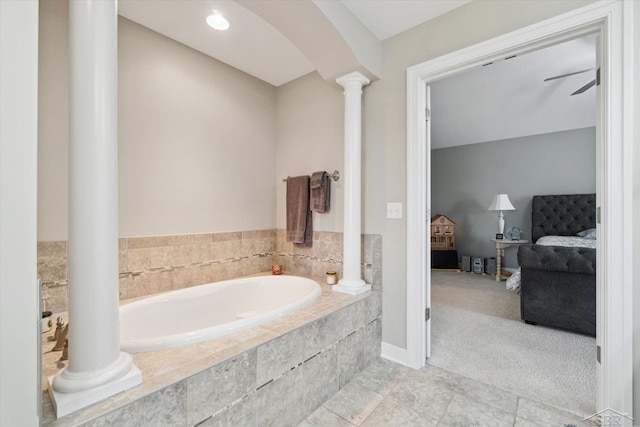 full bathroom with tile patterned flooring, ensuite bath, a garden tub, and ornate columns