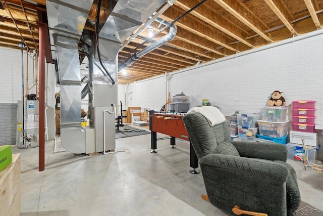 unfinished basement featuring gas water heater and brick wall