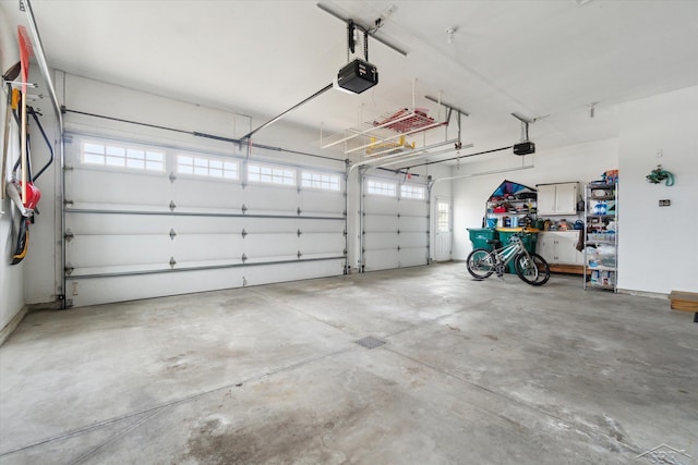 garage with a garage door opener and baseboards