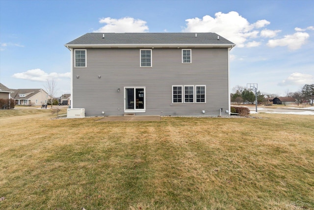 back of property with a patio area and a lawn