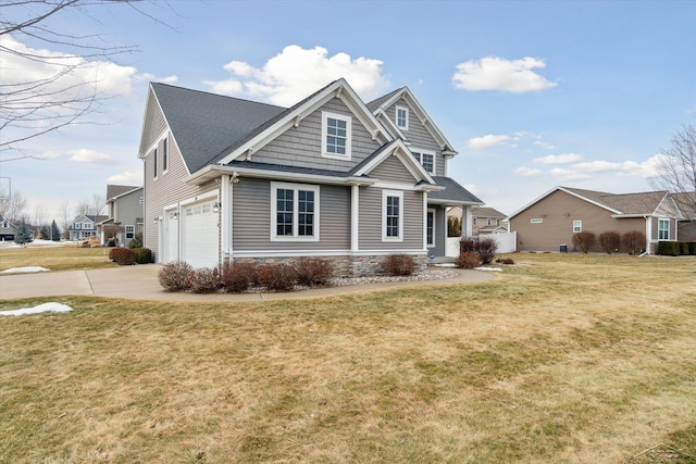 view of front of house featuring driveway, a front lawn, and an attached garage