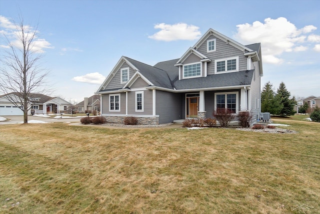 view of front of home featuring central air condition unit and a front yard