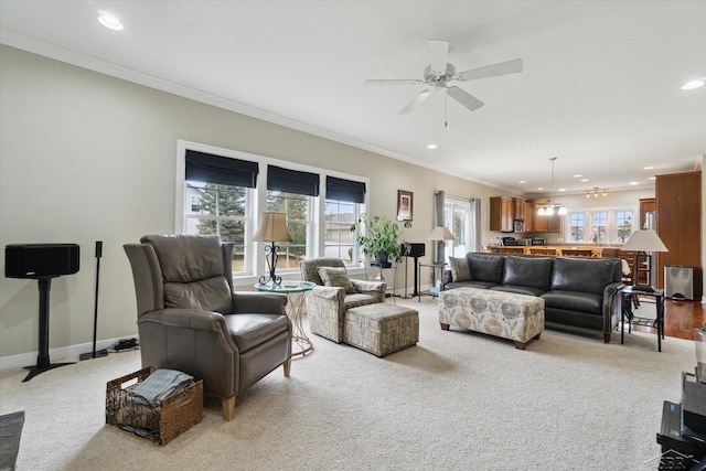 living room with ceiling fan, baseboards, ornamental molding, light carpet, and recessed lighting