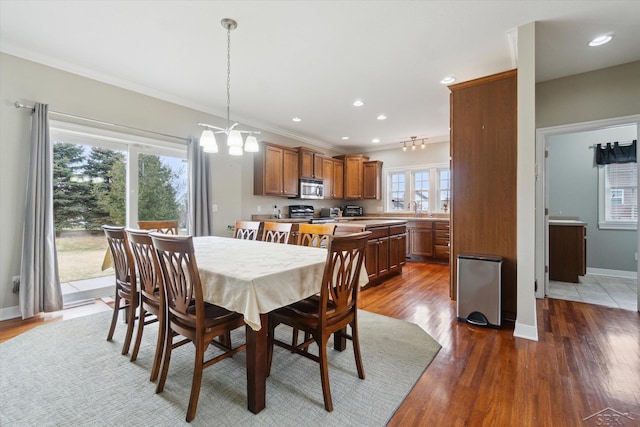 dining room with crown molding, baseboards, recessed lighting, dark wood-style floors, and a notable chandelier