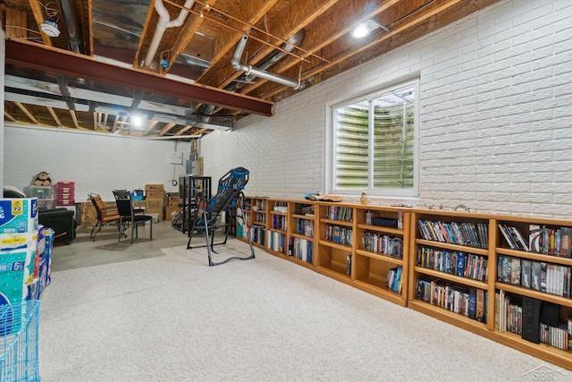 basement featuring brick wall