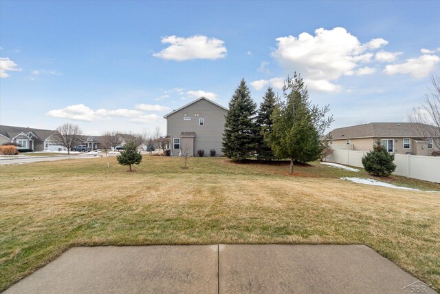 view of yard with a residential view and fence