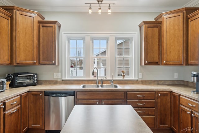 kitchen featuring crown molding, a toaster, brown cabinets, stainless steel dishwasher, and a sink