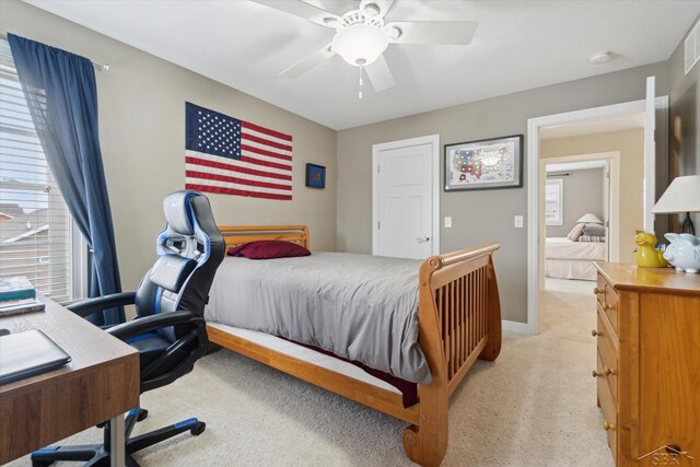 bedroom featuring visible vents, baseboards, light colored carpet, and ceiling fan