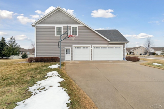 view of front of home featuring a garage, concrete driveway, and a front yard