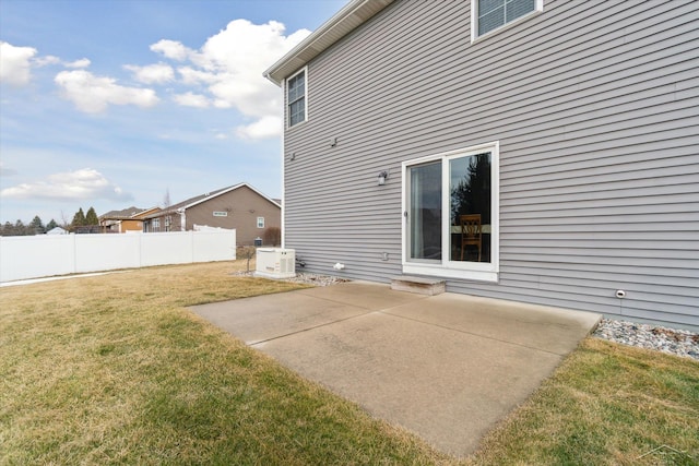 rear view of property with cooling unit, a patio, a lawn, and fence