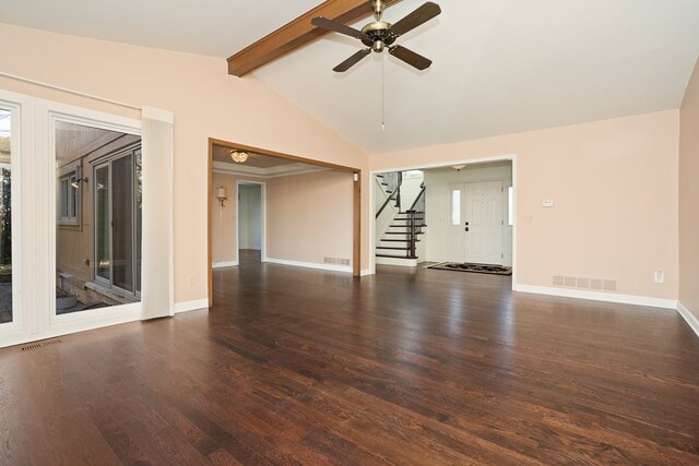 empty room with visible vents, wood finished floors, stairway, baseboards, and vaulted ceiling with beams