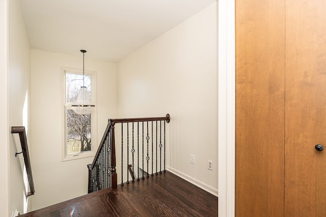 stairs featuring baseboards and wood finished floors