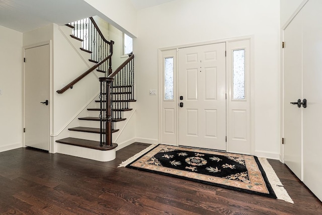 entryway featuring stairway, baseboards, and dark wood-style flooring