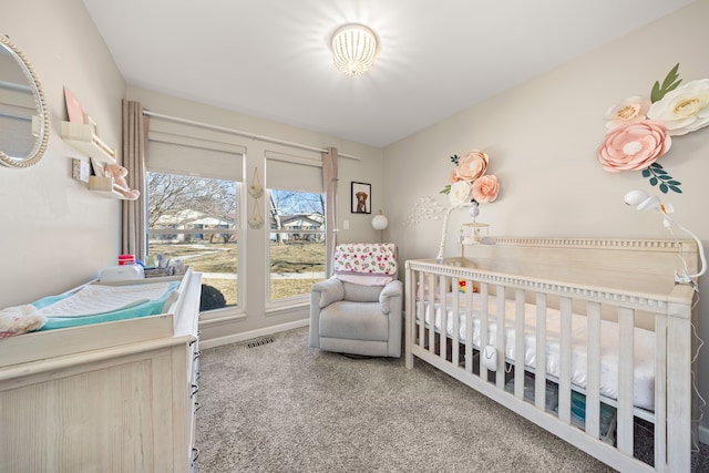 bedroom with visible vents, carpet floors, a nursery area, and baseboards