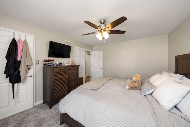 bedroom featuring light carpet, visible vents, and ceiling fan