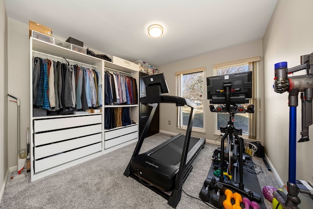 workout room with carpet and baseboards