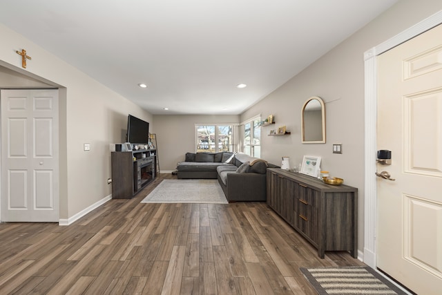 living area featuring recessed lighting, baseboards, wood finished floors, and a fireplace