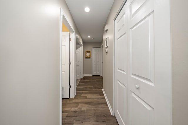 hall featuring recessed lighting, baseboards, and wood finished floors