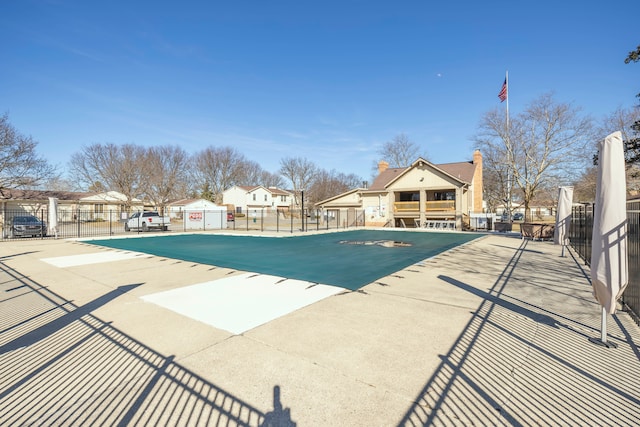 view of swimming pool featuring fence