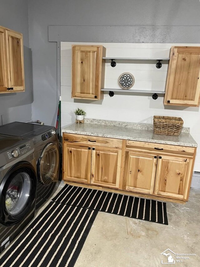 laundry area with washer and dryer and cabinet space