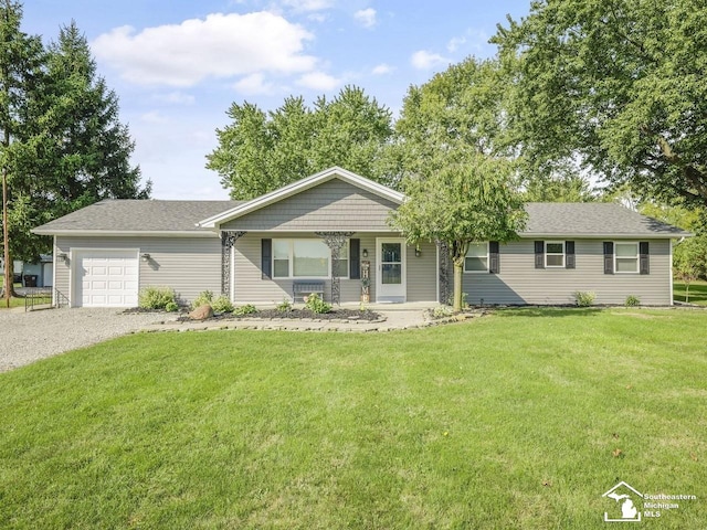 single story home with an attached garage, gravel driveway, and a front yard