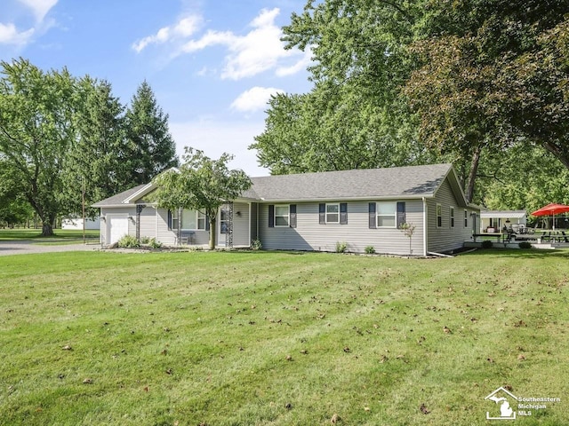 ranch-style house with driveway, a front yard, and an attached garage