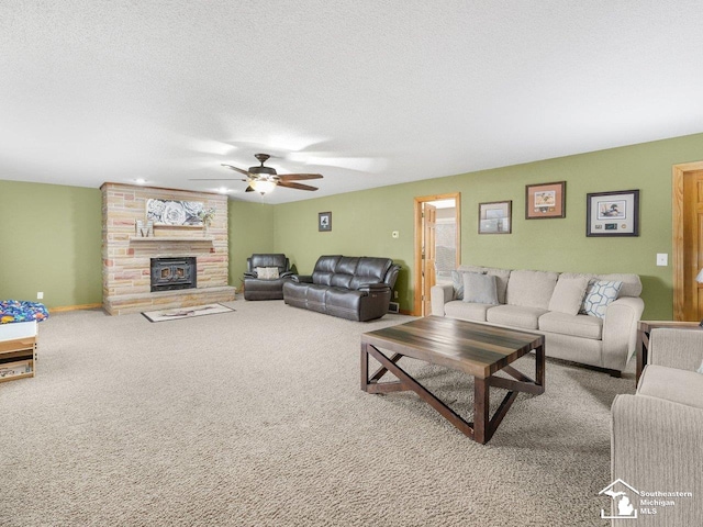 carpeted living area featuring baseboards, a fireplace, a textured ceiling, and ceiling fan