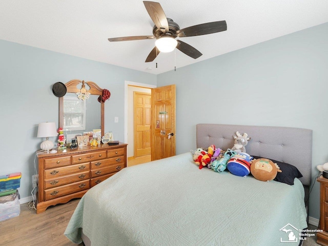 bedroom featuring baseboards, a ceiling fan, and wood finished floors