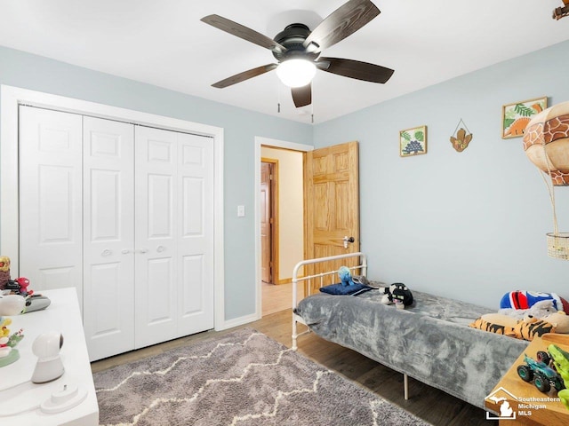 bedroom with a closet, baseboards, ceiling fan, and wood finished floors