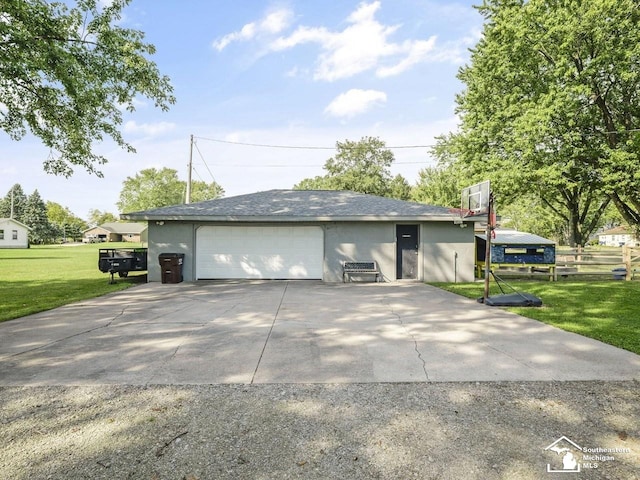 garage featuring driveway and fence