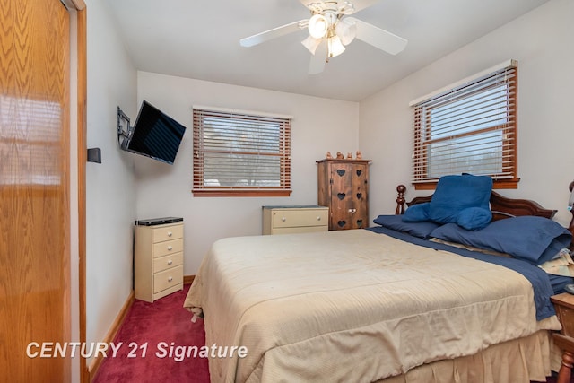 bedroom with baseboards, multiple windows, ceiling fan, and carpet flooring