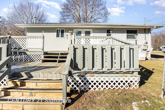 rear view of property with a wooden deck