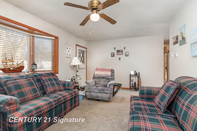 carpeted living room with ceiling fan