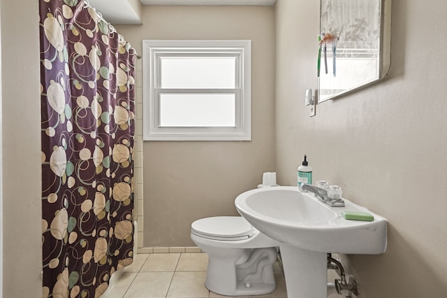 full bathroom with tile patterned floors, curtained shower, and toilet