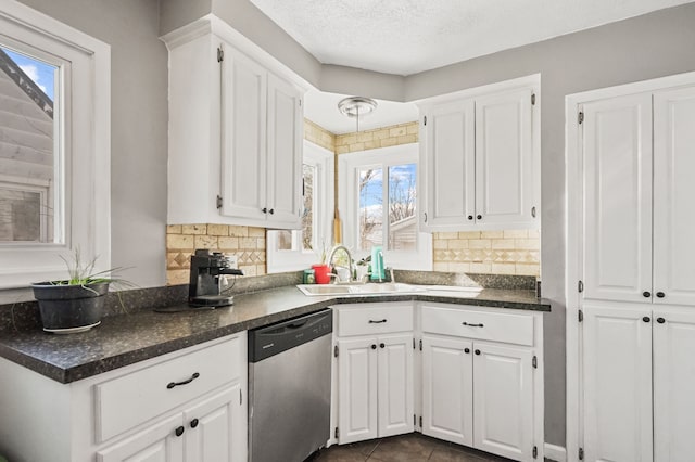 kitchen with a sink, dishwasher, and white cabinets