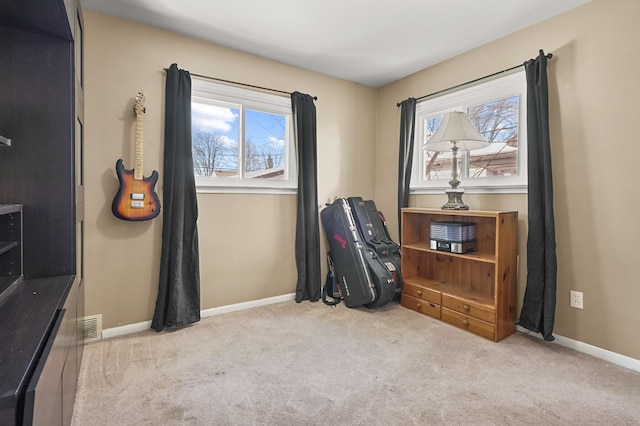 interior space featuring visible vents, baseboards, and carpet