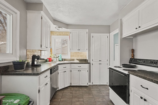 kitchen featuring stainless steel dishwasher, dark countertops, white cabinets, and electric range oven