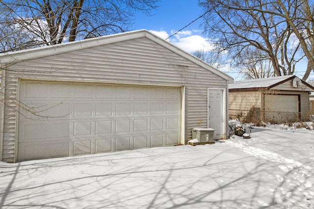 snow covered garage with a garage