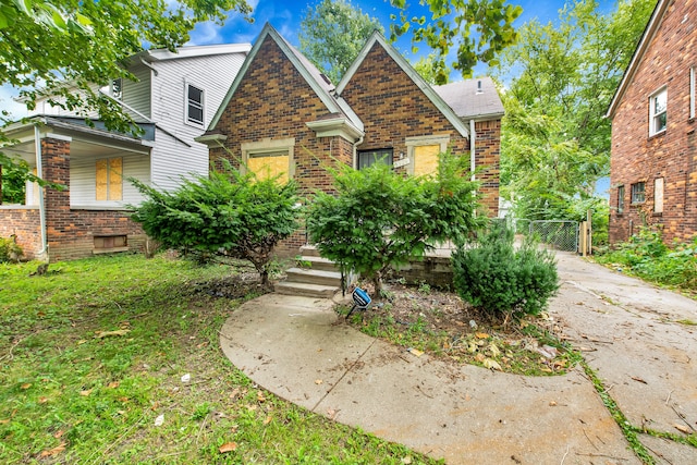 5984 Courville St, Detroit, MI 48224 - view of front facade with brick siding and a gate