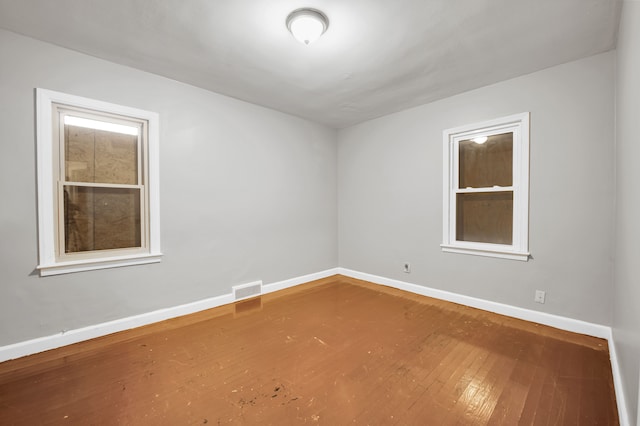 5984 Courville St, Detroit, MI 48224 - unfurnished room featuring visible vents, baseboards, and hardwood / wood-style flooring