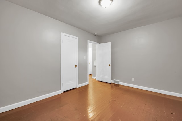 5984 Courville St, Detroit, MI 48224 - spare room with visible vents, baseboards, and wood-type flooring