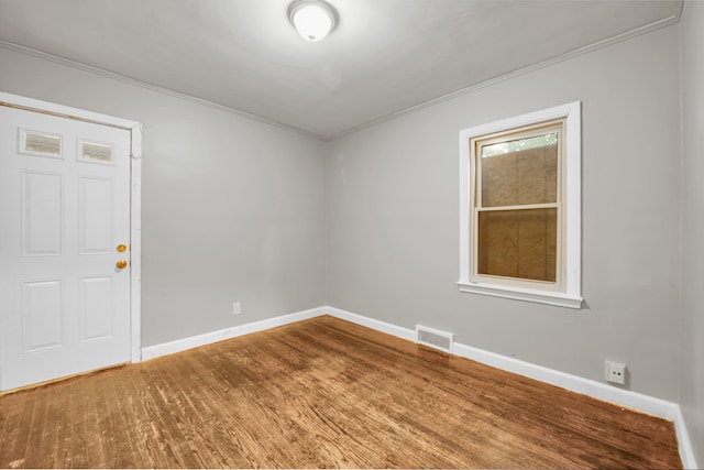 5984 Courville St, Detroit, MI 48224 - empty room with visible vents, ornamental molding, baseboards, and wood finished floors
