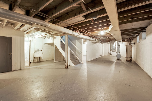 5984 Courville St, Detroit, MI 48224 - unfinished basement with stairway, gas water heater, concrete block wall, and a sink