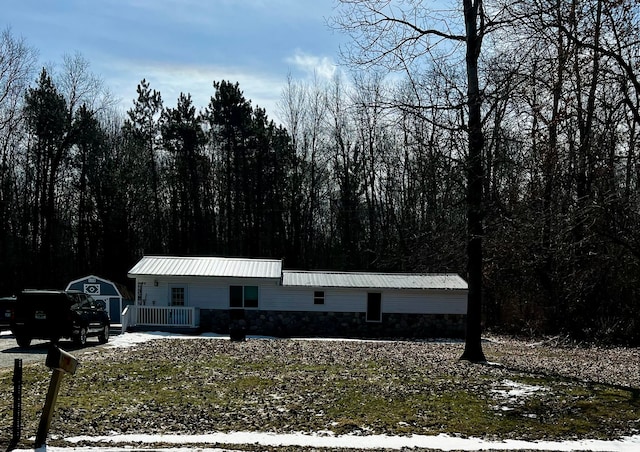 manufactured / mobile home with metal roof and a forest view