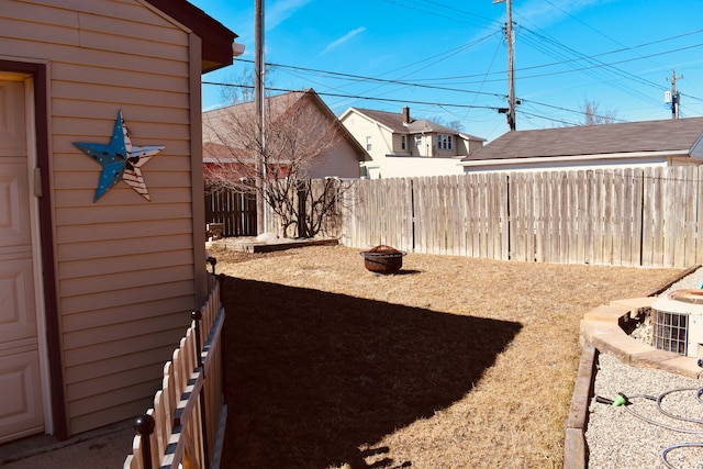 view of yard with a fire pit and a fenced backyard