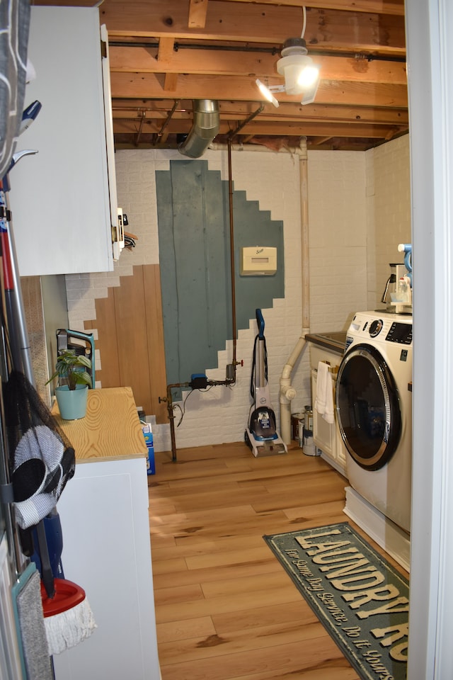 laundry room featuring washer / dryer and light wood-style flooring