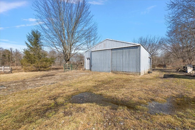 view of yard with an outbuilding, fence, a garage, and an outdoor structure