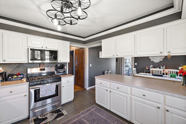 kitchen featuring decorative backsplash, appliances with stainless steel finishes, white cabinetry, and light countertops