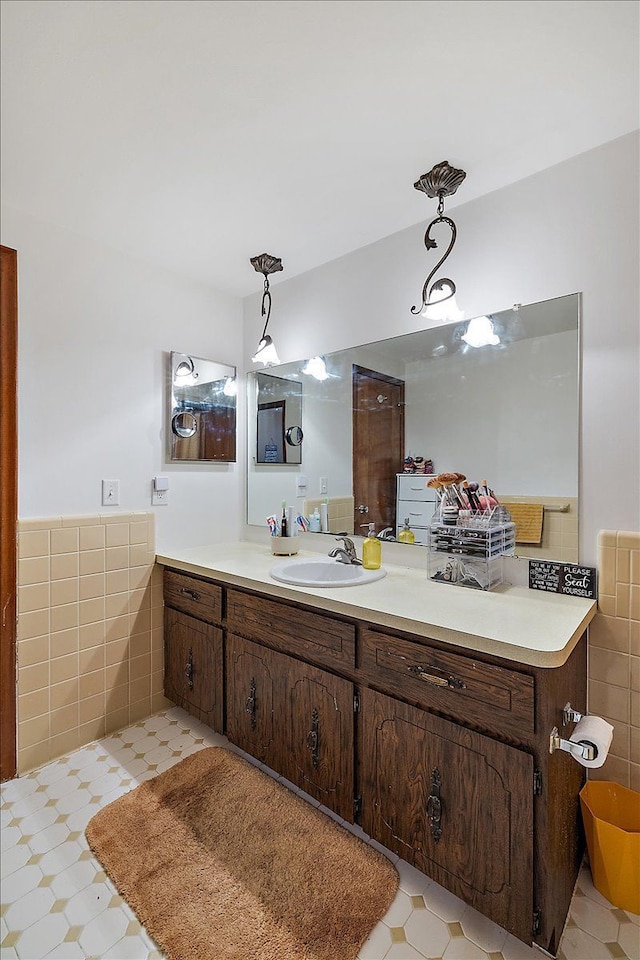 bathroom with wainscoting, tile walls, and vanity